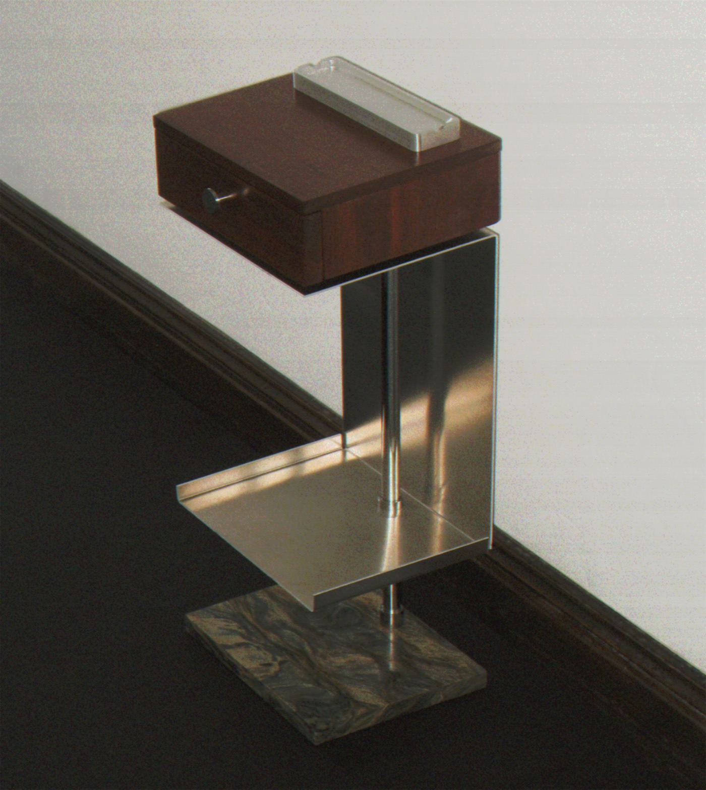 Side table with a dark wood drawer box on a folded stainless-steel frame and a stone base, set against a white wall.